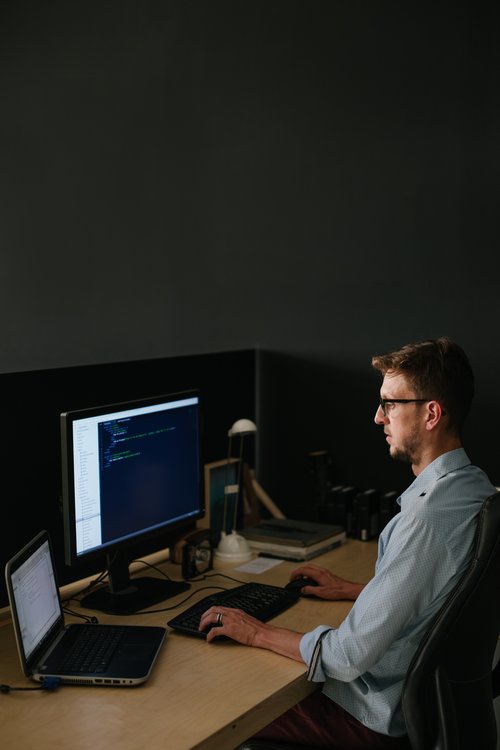 A website/software developer busy coding in his studio