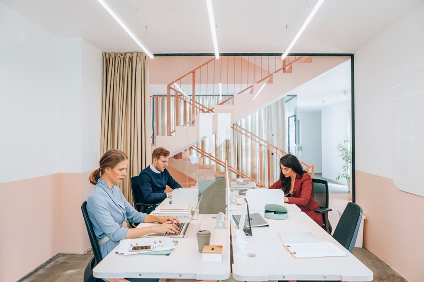 People working from desks and collaborating