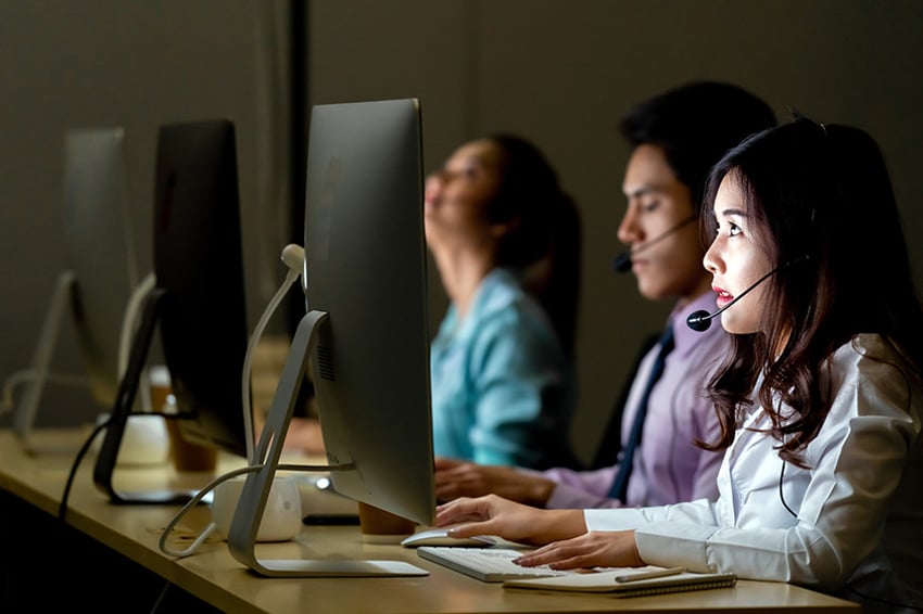 Call centre with agents at computer monitors