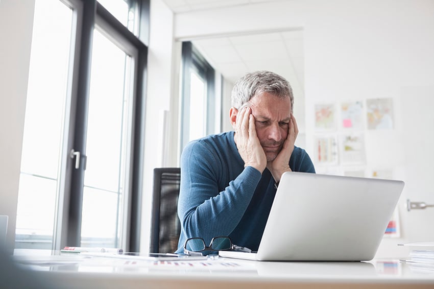 Man staring at laptop computer screen