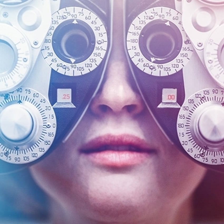 A woman's eyes being tested using a Photopter. Could also depict an ophthalmologist.  