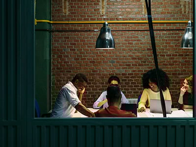 Business Group In A Meeting Room In The Office Team at work. Group of business people working and communicating together in creative office.